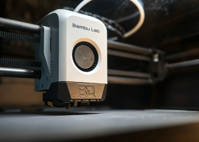 Close-up of a 3D printer head in operation